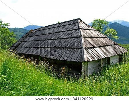 Abandoned And Forgotten Gutsul House High In Green Mountains. Picturesque Summer Mountain Landscape 