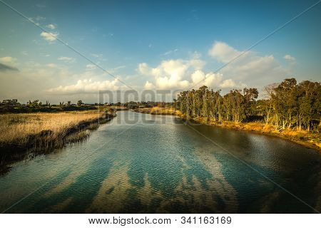 Cloudy Sky Over Calik Lagoon At Sunset. Sardinia, Italy
