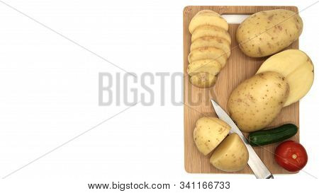 Board With Fresh, Raw Vegetables, Top View. Knife, Board, Tomato, Cucumber. Isolated Objects On A Wh