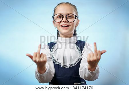 School Girl In Glasses Showing Middle Finger. An Insulting Gesture. A Bratty Child