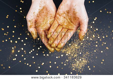 Beautiful Hands In Golden Paint On Black Fastive Background Close Up