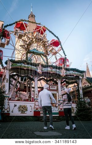 Young Couple Visit The Christmas Market In Cologne Germany During A City Trip, Men And Woman At Chri