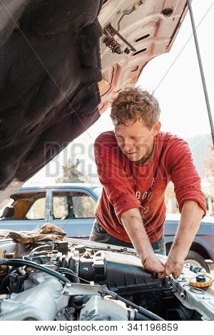 The Concept Of Disability Of People And Their Adaptation To Life. Blond Disabled Man Repairs The Eng