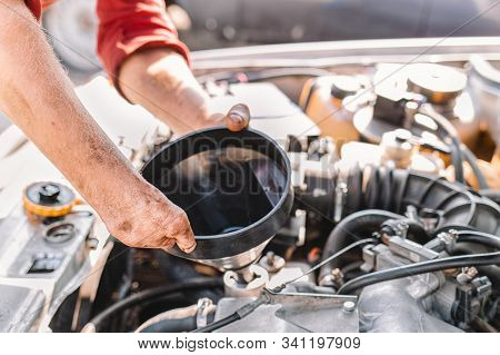 The Concept Of Disability Of People And Their Adaptation To Life. A Disabled Man Repairs A Car, Pour