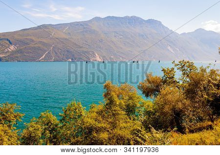 Garda Lake, Lombardy, Italy - September 12, 2019: High Black Sails Of Sailing Boats Moving Fast With