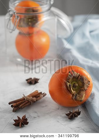 Delicious Fresh Persimmon Fruit On A Gray Table. Close-up. Ingredients For Persimmon Jam.