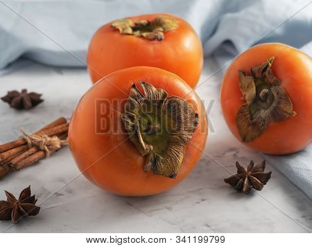 Delicious Fresh Persimmon Fruit On A Gray Table. Close-up. Ingredients For Persimmon Jam.