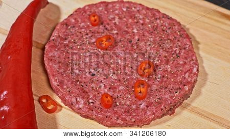Cook Makes Meat Medallions For Burgers. Chef In Black Food Gloves Makes Cutlet. Cutlets Are Leveled 