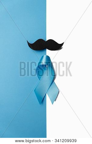 Light Blue Ribbon With Mustache On White And Blue Background. Prostate Cancer Awareness, Movember Me