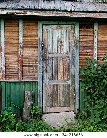 Old door of time-worn ramshackle house.