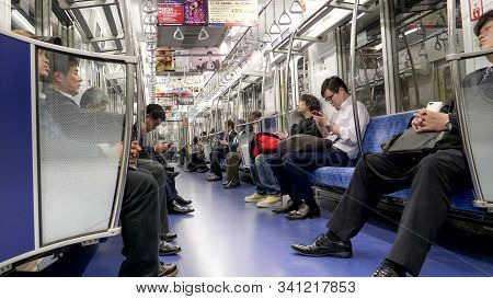 Tokyo, Japan - April, 10, 2018: Commuters In A Subway Car At Tokyo