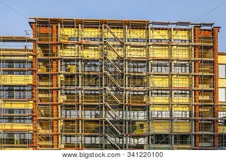 Scaffolding Arround The House To Install Thermal Insulation Of The Apartment Building Facade