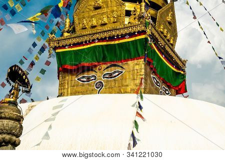 The Upper Part Of The Stupa In Buddhist Temple Swayambhunath In Kathmandu. The Image Of Buddhas Eyes