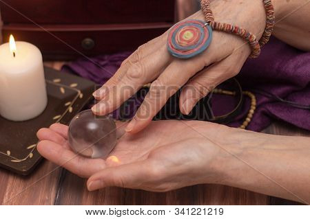 Woman Fortune Teller Holds A Ball Of Fate In Her Hands, A Magic Ball Of Predictions. The Concept Of 