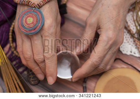 Woman Fortune Teller Holds A Ball Of Fate In Her Hands, A Magic Ball Of Predictions. The Concept Of 