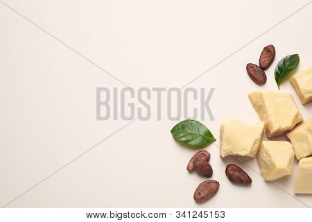 Organic Cocoa Butter And Beans On Beige Background, Flat Lay. Space For Text