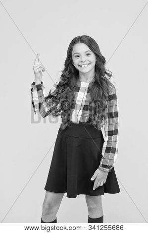 My Idea. Little Child Pointing Finger Up Yellow Background. Adorable Schoolgirl Got Idea. Expressing