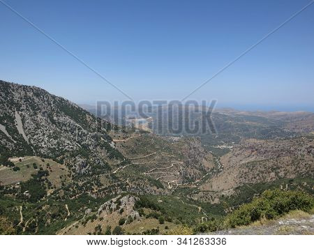 Beautiful Panorama Of Stone Mountains, Trees And Blue Sky