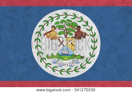Belize Flag Depicted In Bright Paint Colors On Old Relief Plastering Wall. Textured Banner On Rough 