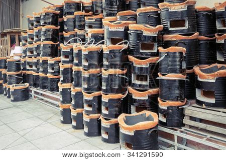 Many Ancient Charcoal Stoves Arranged In A Row Orderly For Sale To Asian Customers At The Grocery St
