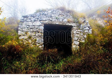 Ruin Of Stone Farmhouse Shrouded In November Fog On The Path To Monte Pau In Cogollo Del Cengio In T