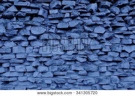 Toned Blue Pattern Of Old Style Design Decorative Cracked Real Stone Wall Surface With Cement. Trend