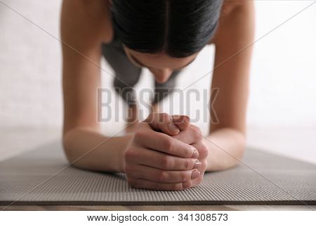 Young Woman Practicing Forearm Plank Asana In Yoga Studio, Closeup. Phalankasana Pose Variation