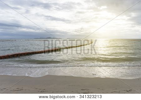 Sunset Or Sunrise With The View Of Calm And No Waves Sea With Modular Floating Pontons And Sand At A