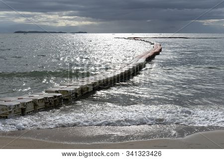 Sunset Or Sunrise With The View Of Calm And No Waves Sea With Modular Floating Pontons And Sand At A