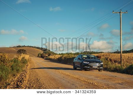 Cambara Do Sul, Brazil, July 17, 2019. Car On Dirt Road Passing Through Rural Lowlands Called Pampas