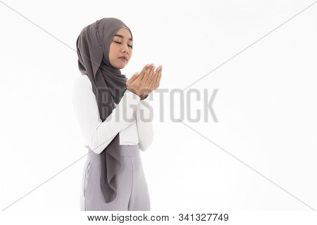 Young Adult Muslim Woman girl making Duas for Muslim god blessing prayer. Studio shot of woman isolated on white background