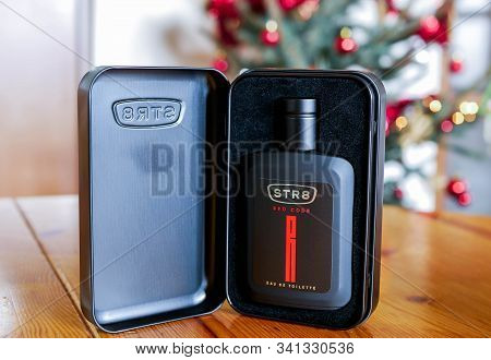 Miercurea Ciuc, Romania- 24 December 2019: Str8 Red Code Fragrance On Pine Wood Table, Glowing Chris