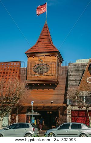 Gramado, Brazil - July 21, 2019. Wooden Facade Of Chocolate World Store With Signboard And Tower On 