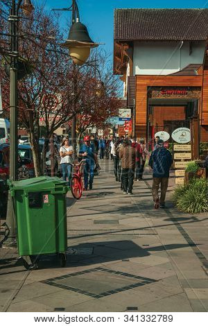 Gramado, Brazil - July 21, 2019. Buildings With Shops And People Walking On Sidewalk At Gramado. A C