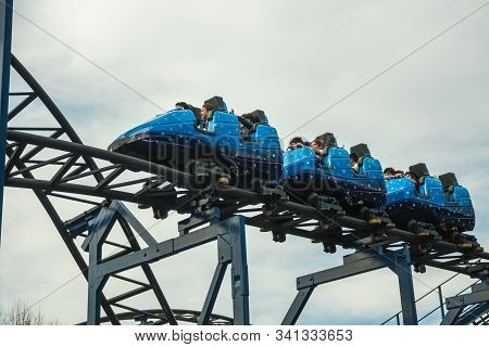 People Having Fun On A Roller Coaster