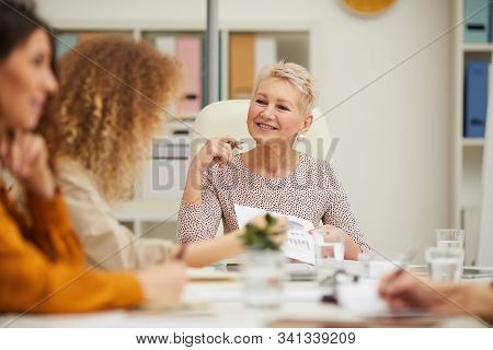 Mature Caucasian Boss Having Active Discussion With Her Emplyees At Business Meeting, Horizontal Eye