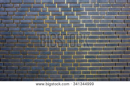 Full Frame Abstract Dark Brick Wall With Golden Gaps