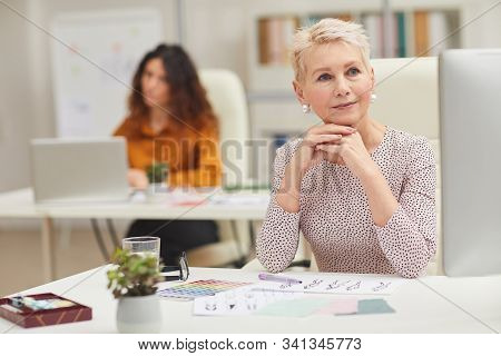 Two Women Working As Fashion Designers In Modern Offiice Horizontal Portrait