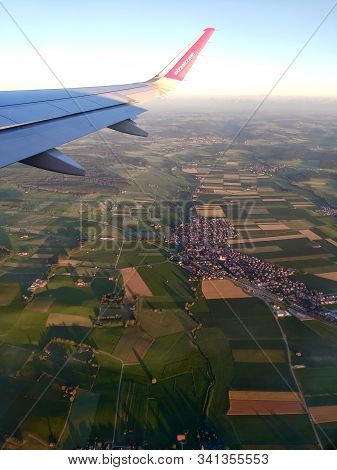 Munich, Germany - June 28, 2019: Airbus A321 Plane Of Wizz Air Flying Over City In Germany. Aerial V