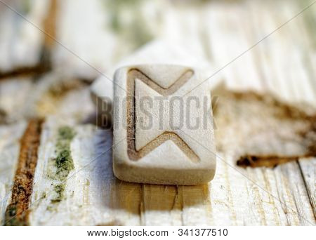 Wooden Rune Perth Close-up On A Wooden Background. Soft Focus