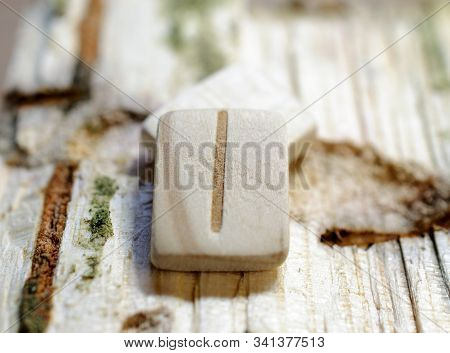 Wooden Rune Isa Close-up On A Wooden Background. Soft Focus