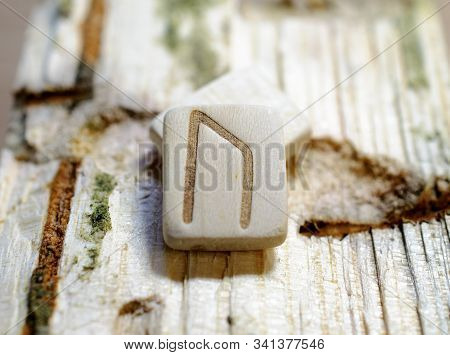 Wooden Rune Uruz Close-up On A Wooden Background. Soft Focus