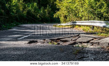 Damaged Asphalt Road Due To Falling Rocks On A Mountain Road In The Italian Apennines Of The Lazio R