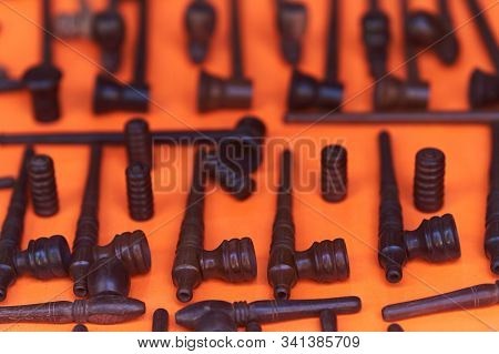 Different Pipes Smoking Tobacco On An Orange Background. Top View.