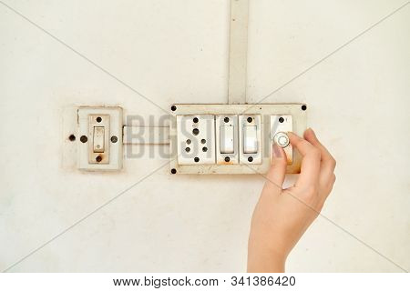 The Girl Controls The Power Of The Fan. The Girl Turns The Wall Switch.