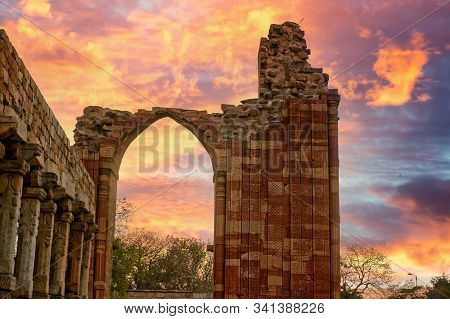 Broen Arch At The Qutub Minar Framing A Clouded Sky. Highlights The Need To Preserve Our National Mo