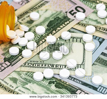 Perscription Drugs Spill Out On To Us Dollar Bills, One Hundred And Fifty Dollars.
