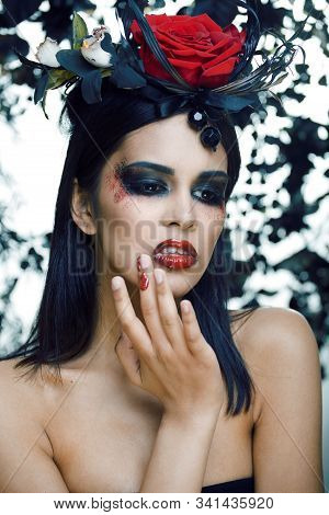 Pretty Brunette Woman With Rose Jewelry, Black And Red, Bright Make Up Kike A Vampire Closeup Red Li