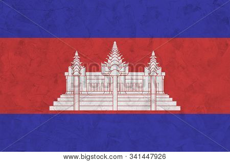 Cambodia Flag Depicted In Bright Paint Colors On Old Relief Plastering Wall. Textured Banner On Roug