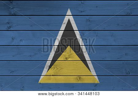 Saint Lucia Flag Depicted In Bright Paint Colors On Old Wooden Wall. Textured Banner On Rough Backgr